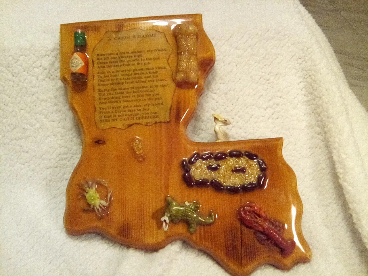 Louisiana-shaped decoupage plaque with A Cajun Welcome by Bob Hamm